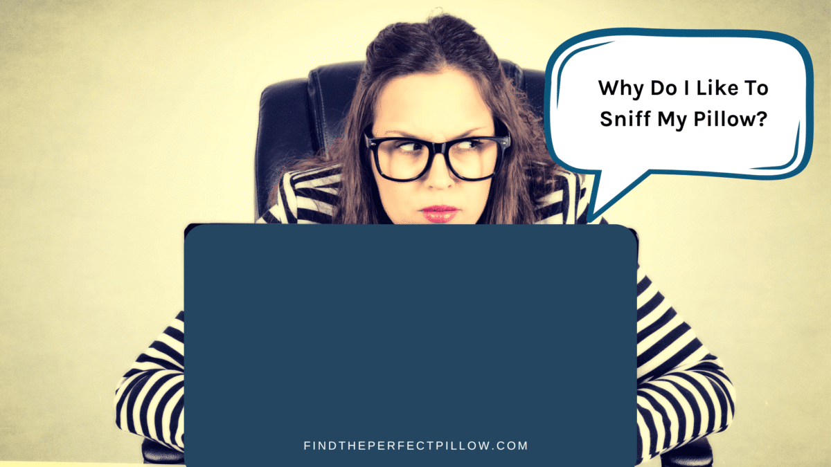 Person with glasses sitting at a desk, looking curious and skeptical, with a thought bubble asking, 'Why Do I Like to Sniff My Pillow?'